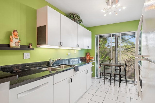 1718 Northfield Sq Unit F, Northfield, IL 60093 - kitchen with fridge, light tile patterned flooring, a sink, white cabinetry, and a chandelier