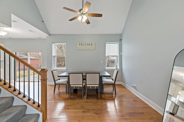 15256 State St, South Holland, IL 60473 - dining space with a ceiling fan, stairs, light wood-style floors, baseboards, and high vaulted ceiling