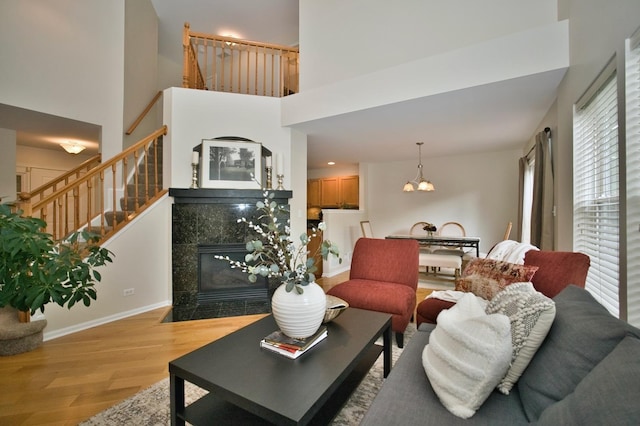 6131 Wingate Dr, Lisle, IL 60532 - living room featuring wood finished floors, a high ceiling, baseboards, stairs, and a fireplace