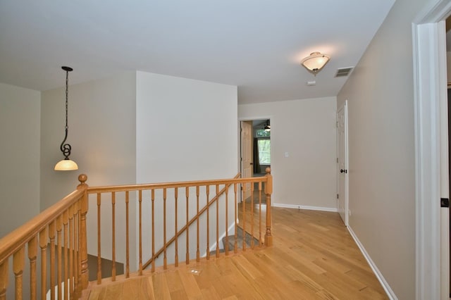 6131 Wingate Dr, Lisle, IL 60532 - hall with an upstairs landing, light wood-style flooring, and baseboards