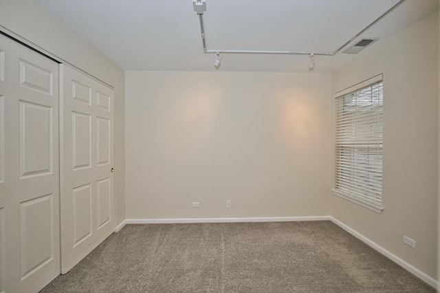 6131 Wingate Dr, Lisle, IL 60532 - unfurnished bedroom with rail lighting, carpet floors, and baseboards