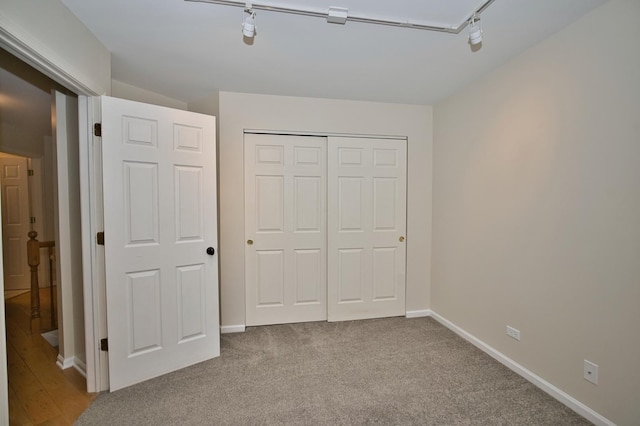 6131 Wingate Dr, Lisle, IL 60532 - unfurnished bedroom with track lighting, a closet, baseboards, and carpet