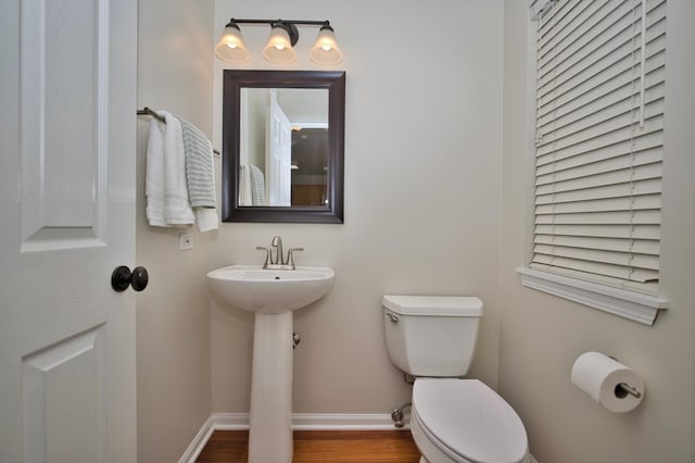 6131 Wingate Dr, Lisle, IL 60532 - bathroom featuring toilet, baseboards, wood finished floors, and a sink