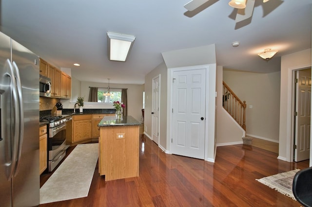 6131 Wingate Dr, Lisle, IL 60532 - kitchen with stainless steel appliances, dark wood finished floors, baseboards, a peninsula, and decorative light fixtures