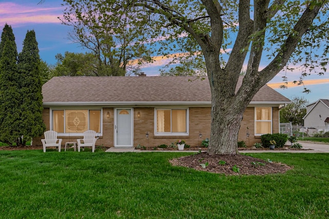 1455 Reckinger Rd, Aurora, IL 60505 - ranch-style house with brick siding, a lawn, roof with shingles, and a chimney
