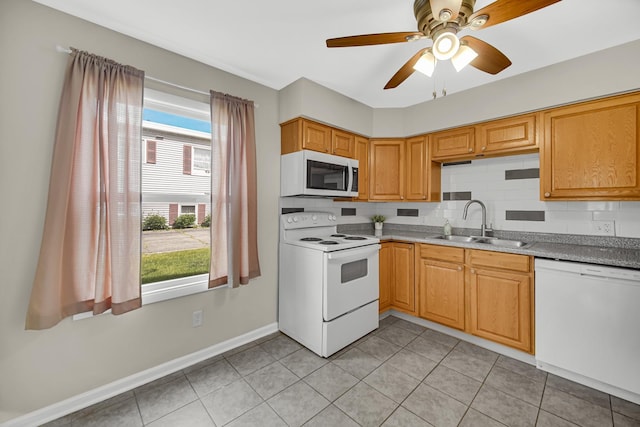 1455 Reckinger Rd, Aurora, IL 60505 - kitchen with white appliances, a sink, a ceiling fan, decorative backsplash, and baseboards