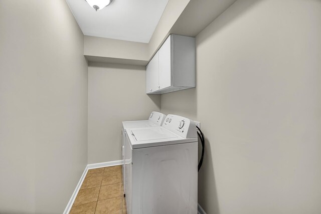 1455 Reckinger Rd, Aurora, IL 60505 - washroom featuring cabinet space, washing machine and clothes dryer, baseboards, and light tile patterned flooring