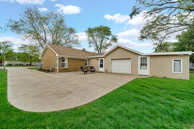 1455 Reckinger Rd, Aurora, IL 60505 - rear view of house featuring concrete driveway, an attached garage, a yard, and brick siding