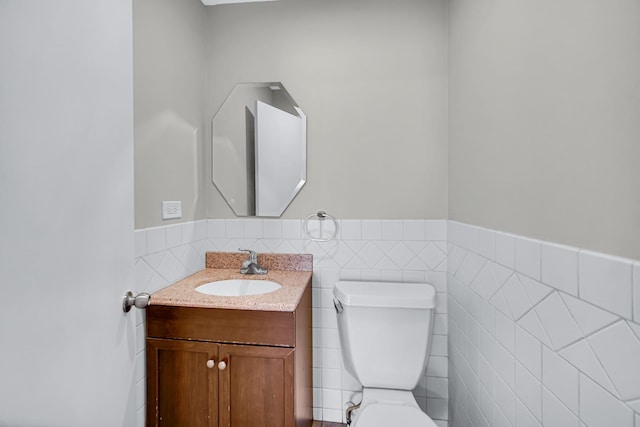 1455 Reckinger Rd, Aurora, IL 60505 - bathroom with toilet, tile walls, wainscoting, and vanity