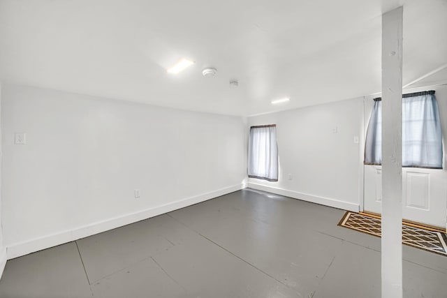 1455 Reckinger Rd, Aurora, IL 60505 - empty room featuring baseboards, a smoke detector, and finished concrete floors