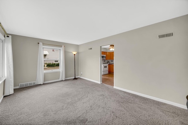 1455 Reckinger Rd, Aurora, IL 60505 - spare room with light carpet, baseboards, and ceiling fan