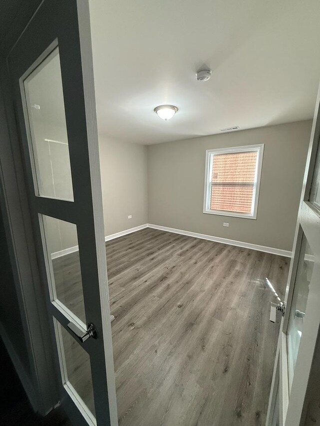 363 Indianwood Blvd, Park Forest, IL 60466 - empty room with dark wood-style floors, healthy amount of natural light, and french doors