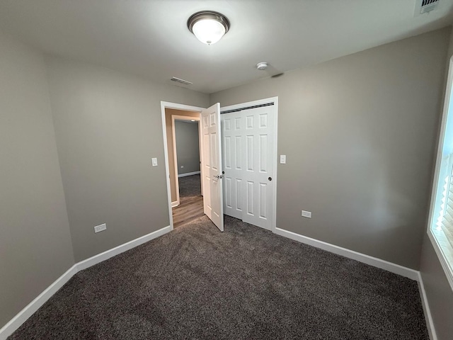363 Indianwood Blvd, Park Forest, IL 60466 - unfurnished bedroom with dark colored carpet and a closet