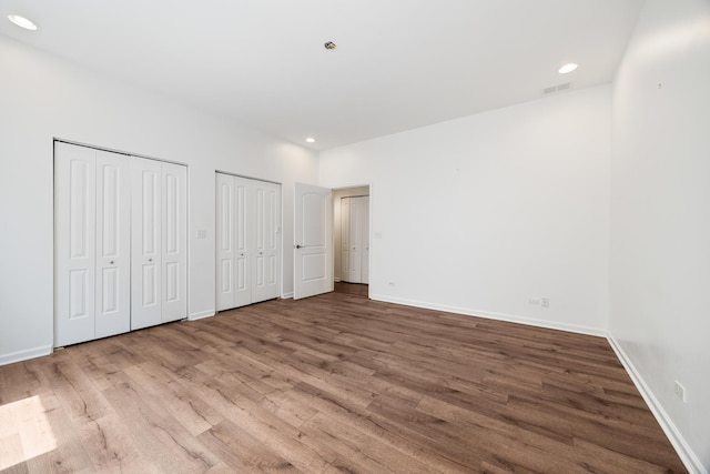 4800 S St Lawrence Ave Unit 3S, Chicago, IL 60615 - unfurnished bedroom with two closets, wood finished floors, and recessed lighting
