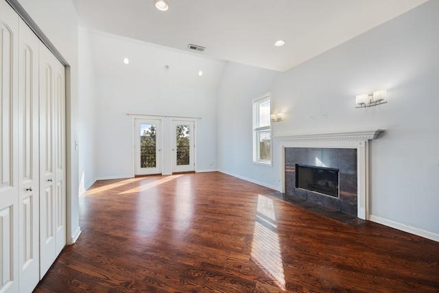 4800 S St Lawrence Ave Unit 3S, Chicago, IL 60615 - unfurnished living room featuring vaulted ceiling, wood finished floors, a tile fireplace, and recessed lighting