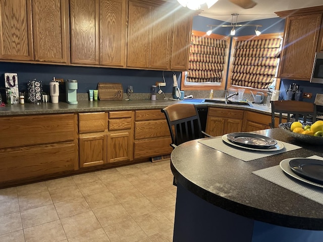 12409 44th Ct, Alsip, IL 60803 - kitchen featuring a sink, stainless steel microwave, dark countertops, and brown cabinetry