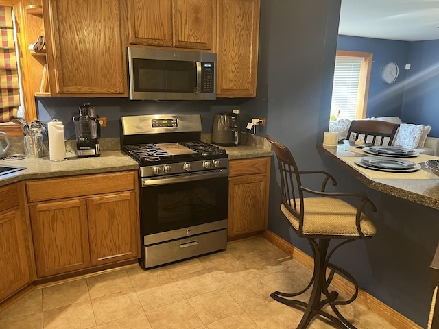 12409 44th Ct, Alsip, IL 60803 - kitchen featuring stainless steel appliances, brown cabinetry, and baseboards