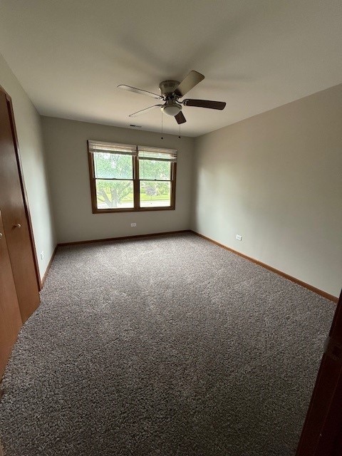 674 E Algonquin Rd, Des Plaines, IL 60016 - carpeted spare room with a ceiling fan and baseboards
