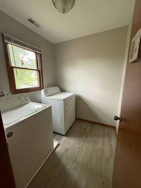 674 E Algonquin Rd, Des Plaines, IL 60016 - washroom with washing machine and dryer, light wood-style floors, and baseboards