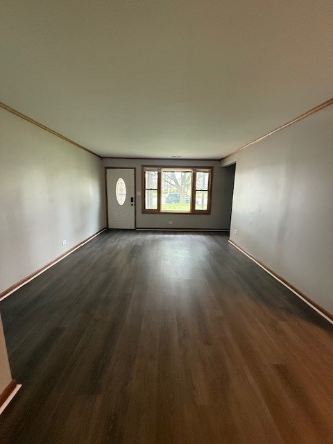 674 E Algonquin Rd, Des Plaines, IL 60016 - unfurnished living room featuring dark wood-type flooring and baseboards