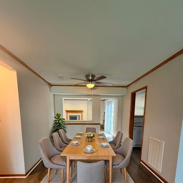 674 E Algonquin Rd, Des Plaines, IL 60016 - dining room featuring crown molding, dark wood-type flooring, ceiling fan, and baseboards