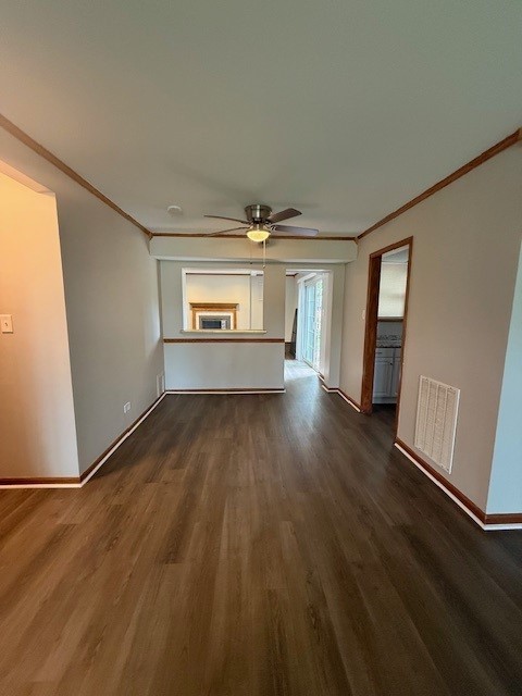 674 E Algonquin Rd, Des Plaines, IL 60016 - unfurnished living room with ceiling fan, dark wood finished floors, baseboards, and ornamental molding