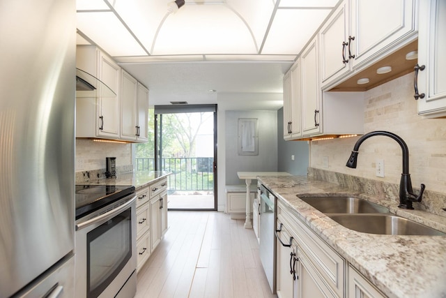 2 S Atrium Way Unit 208, Elmhurst, IL 60126 - kitchen with appliances with stainless steel finishes, a sink, tasteful backsplash, light stone countertops, and white cabinets