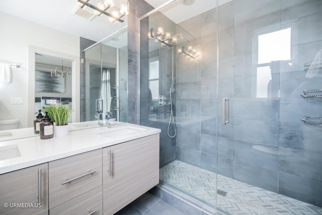 1221 E 46th St Unit 1, Chicago, IL 60653 - full bath with a chandelier, double vanity, a shower stall, tile patterned flooring, and toilet