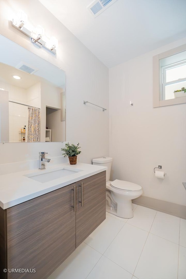 1221 E 46th St Unit 1, Chicago, IL 60653 - bathroom with toilet, vanity, tile patterned flooring, and curtained shower