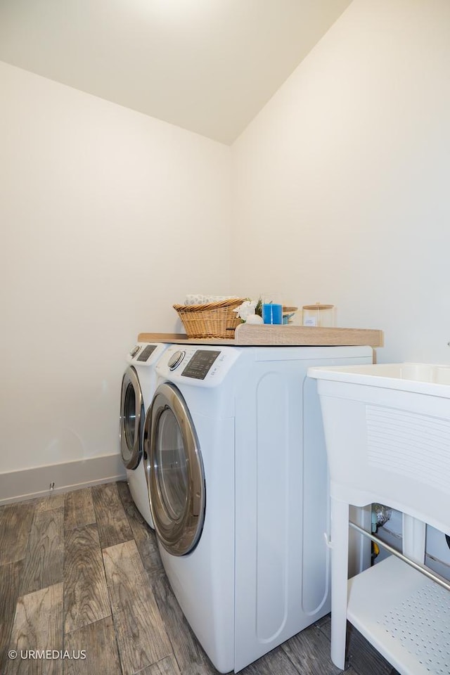 1221 E 46th St Unit 1, Chicago, IL 60653 - washroom with washer and clothes dryer, wood finished floors, and baseboards