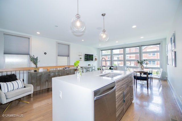 1221 E 46th St Unit 1, Chicago, IL 60653 - kitchen featuring a sink, stainless steel dishwasher, light wood finished floors, light countertops, and a kitchen island with sink