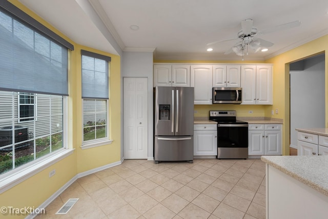 21319 Barth Pond Ln, Crest Hill, IL 60403 - kitchen with appliances with stainless steel finishes, light countertops, white cabinetry, ornamental molding, and a ceiling fan