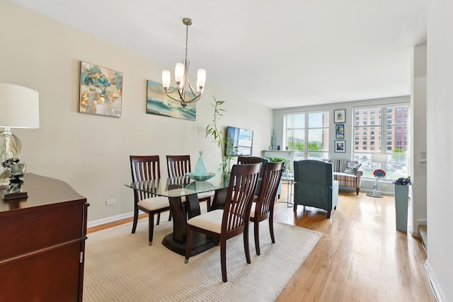 308 E 25th Pl, Chicago, IL 60616 - dining room featuring a chandelier, light wood-type flooring, and baseboards