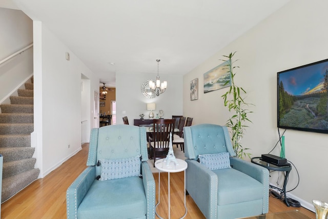 308 E 25th Pl, Chicago, IL 60616 - living area featuring stairs, a chandelier, wood finished floors, and baseboards