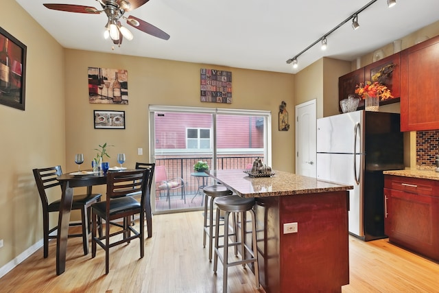 308 E 25th Pl, Chicago, IL 60616 - kitchen featuring freestanding refrigerator, a center island, ceiling fan, and light wood-style floors