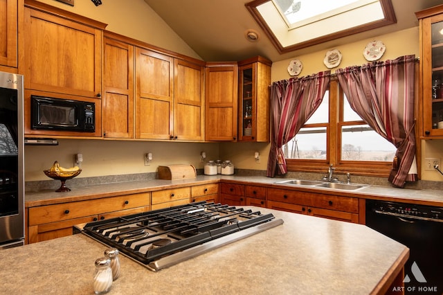 17207 Chase Rd, Dekalb, IL 60115 - kitchen featuring black appliances, a sink, a skylight, vaulted ceiling, and brown cabinets