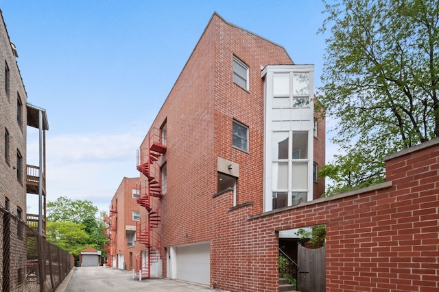 5510 S Cornell Ave Unit E, Chicago, IL 60637 - view of property featuring an attached garage and driveway