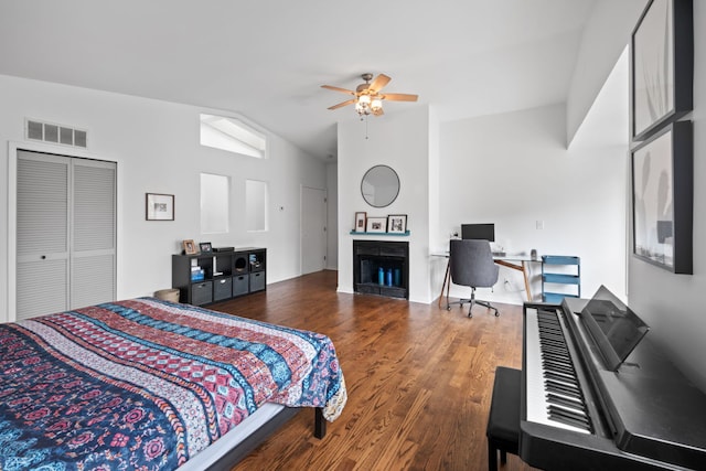 5510 S Cornell Ave Unit E, Chicago, IL 60637 - bedroom with vaulted ceiling, a fireplace, wood finished floors, a desk, and a ceiling fan