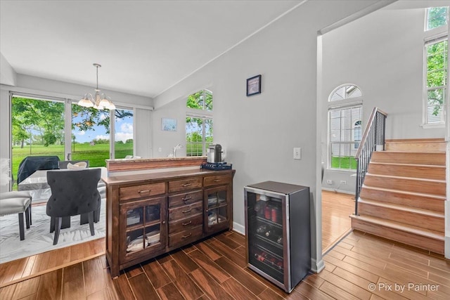 184 Golfview Dr, Glendale Heights, IL 60139 - bar area with beverage cooler, healthy amount of natural light, and dark wood-style floors