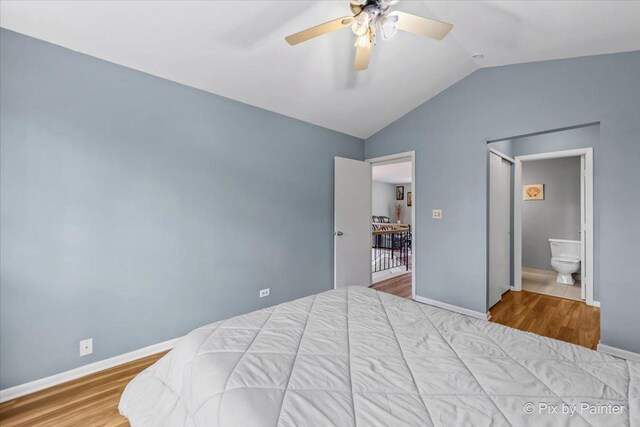 184 Golfview Dr, Glendale Heights, IL 60139 - bedroom with lofted ceiling, wood finished floors, baseboards, connected bathroom, and a ceiling fan