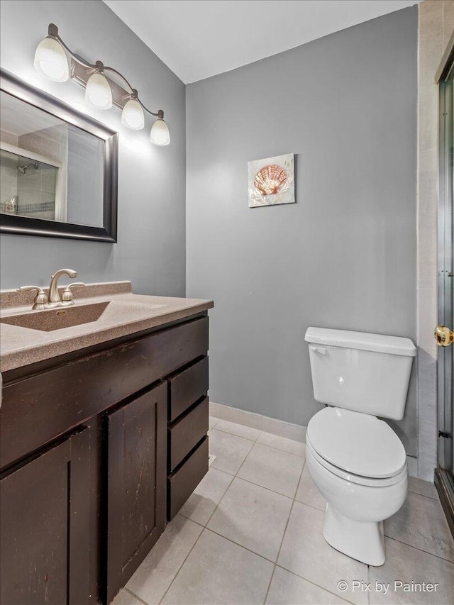 184 Golfview Dr, Glendale Heights, IL 60139 - full bathroom with vanity, toilet, a shower stall, tile patterned floors, and baseboards