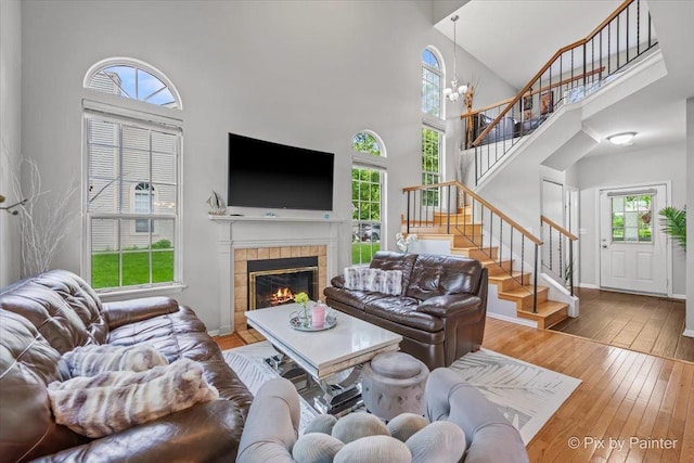 184 Golfview Dr, Glendale Heights, IL 60139 - living area with a high ceiling, healthy amount of natural light, stairway, hardwood / wood-style floors, and a tile fireplace