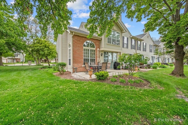 184 Golfview Dr, Glendale Heights, IL 60139 - back of property with a patio area, a yard, brick siding, and a residential view