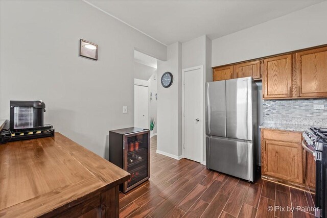 184 Golfview Dr, Glendale Heights, IL 60139 - kitchen featuring appliances with stainless steel finishes, beverage cooler, dark wood-style flooring, decorative backsplash, and brown cabinetry