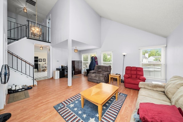 1553 Brandywyn Ct N, Buffalo Grove, IL 60089 - living room featuring high vaulted ceiling, wood finished floors, healthy amount of natural light, and stairs