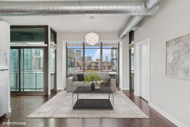 660 W Wayman St Unit 701, Chicago, IL 60661 - living room featuring baseboards and a chandelier