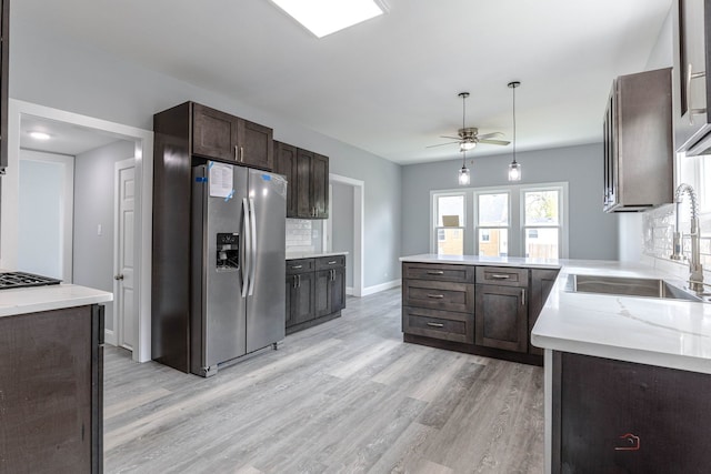 196 Southgate Ave, Chicago Heights, IL 60411 - kitchen with stainless steel fridge with ice dispenser, dark brown cabinetry, light wood-style floors, and a sink