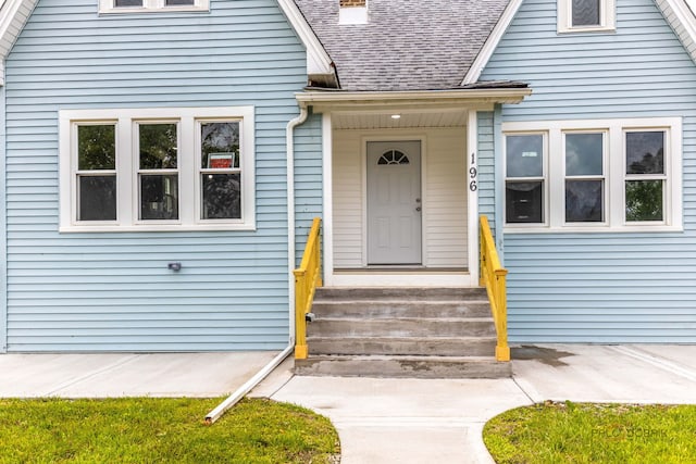 196 Southgate Ave, Chicago Heights, IL 60411 - view of exterior entry featuring a shingled roof and a chimney