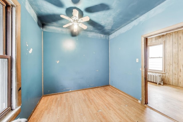 7649 S Dobson Ave, Chicago, IL 60619 - unfurnished room with radiator, wood finished floors, and ceiling fan