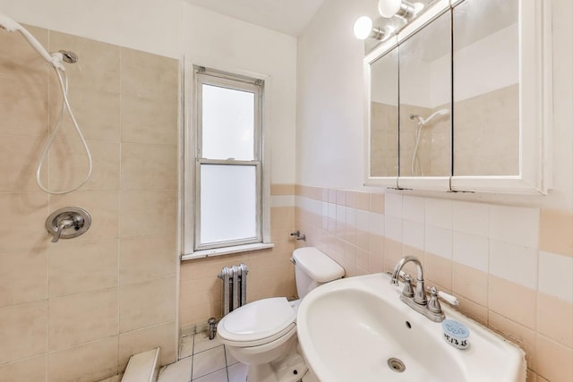 7649 S Dobson Ave, Chicago, IL 60619 - bathroom featuring tiled shower, a sink, tile walls, toilet, and radiator